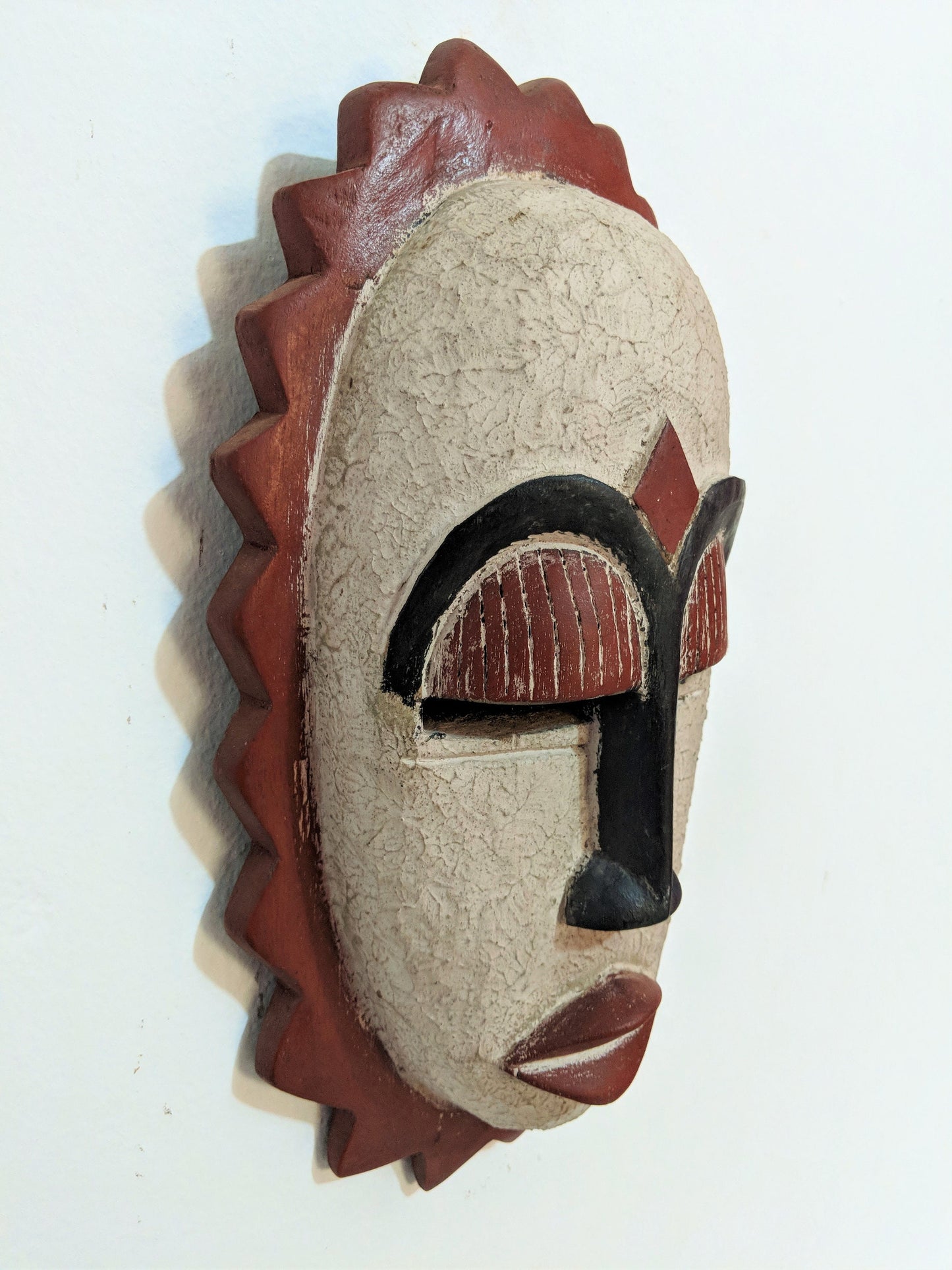 African wooden wall mask. Celebrate the beauty of handmade craftsmanship and give the gift of cultural heritage.