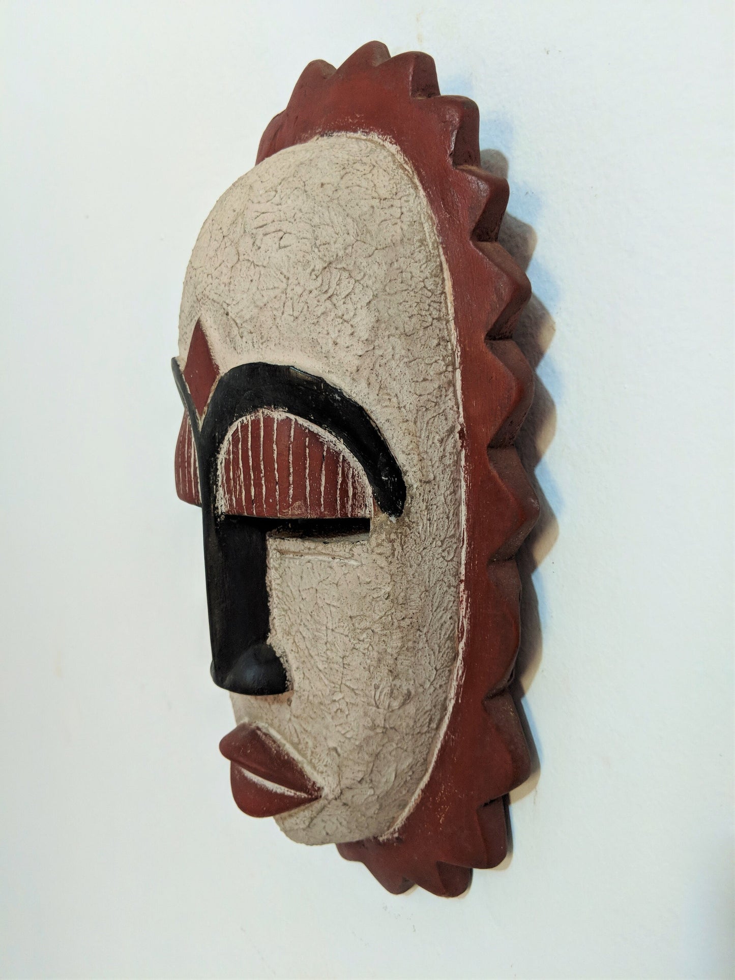 African wooden wall mask. Celebrate the beauty of handmade craftsmanship and give the gift of cultural heritage.